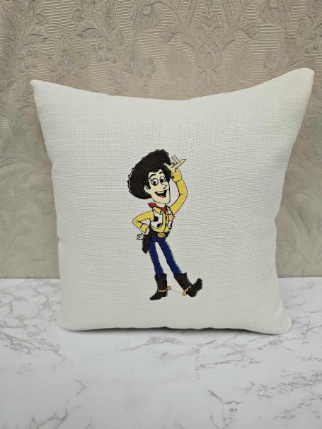 A decorative cushion featuring a cartoon character with a hat and yellow top.