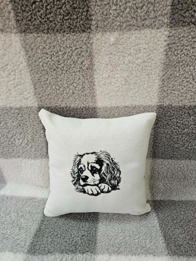 Decorative cushion featuring a sketch of a resting dog on a textured background.