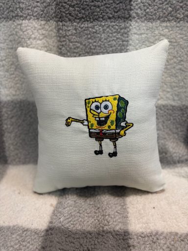 Cushion featuring a cheerful SpongeBob SquarePants illustration.