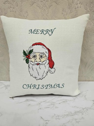 Pillow featuring Santa Claus and "Merry Christmas" text in festive design.