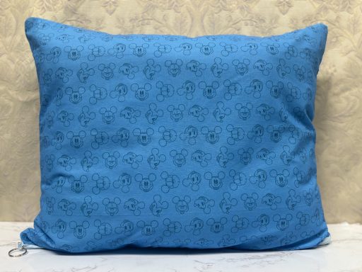 Blue cushion with a patterned design of small black circles and swirls.