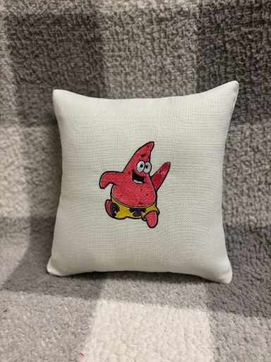 Patrick Star A decorative cushion featuring a cartoon character, Patrick Star, in a playful pose.