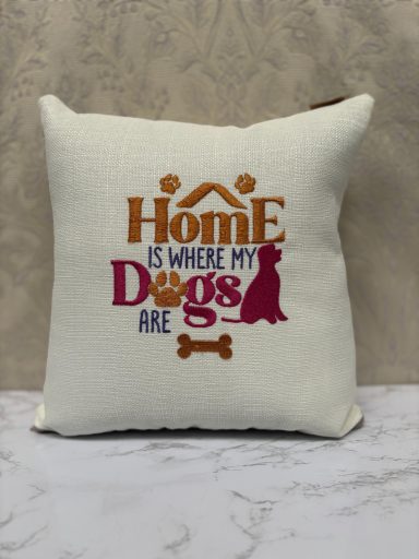 Cushion featuring the phrase "Home is where my dogs are" with dog-related graphics.