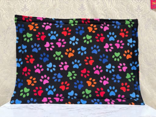 Colourful paw print pattern on a black background.