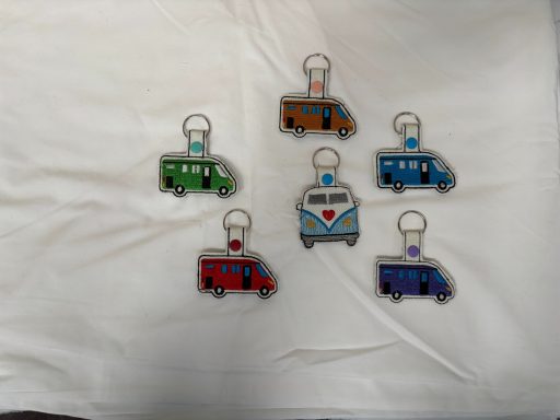 Colourful keychains shaped like vintage vans in various colours.