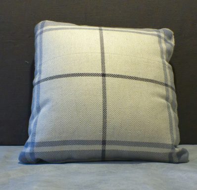 Square cushion with a light grey fabric and blue grid pattern.