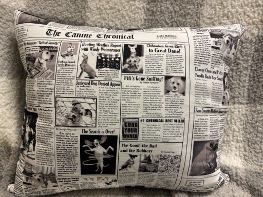 Cushion covered in printed newspaper articles and images.