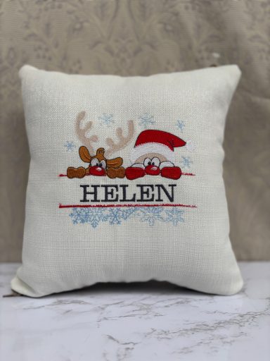 Cushion featuring a reindeer and Santa hat with the name "HELEN" below.