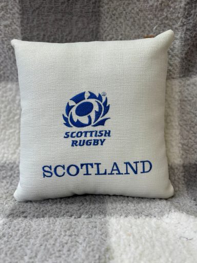 White cushion with "SCOTTISH RUGBY" and Scotland emblem in blue print.