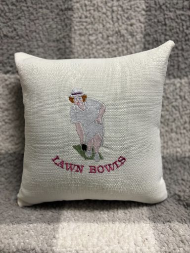 Cushion featuring embroidered lawn bowls player with the text "LAWN BOWLS."