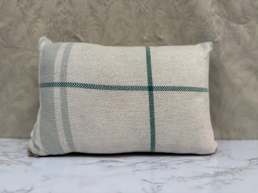 Pillow with a cream background and teal striped pattern.