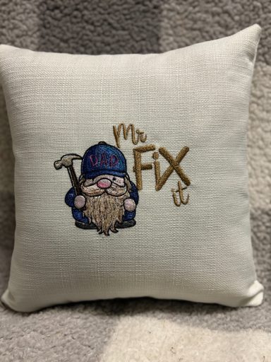 Decorative cushion featuring a gnome with a hat and the text "Mr Fix It."