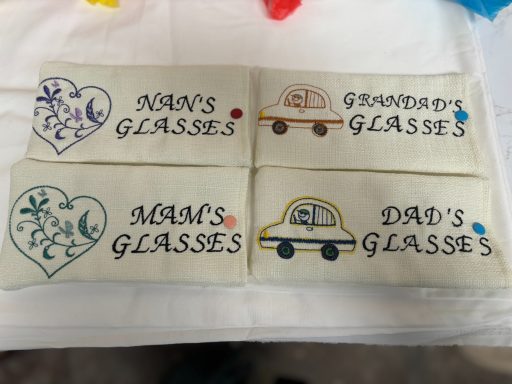 Four fabric labels featuring "NAN's GLASSES," "GRANDAD's," "MUM's GLASSES," and "DAD's GLASSES."