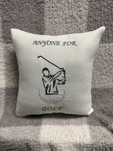Cushion with a golfer illustration and the text "Anyone for Golf?"