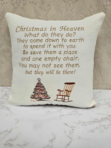 A decorative cushion featuring a Christmas poem and images of a tree and a chair.