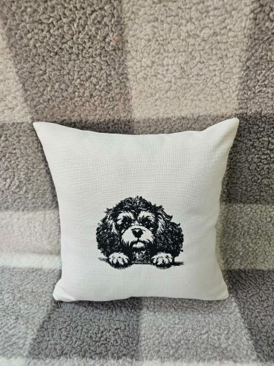 Cushion featuring a black and white illustration of a cute, fluffy dog.