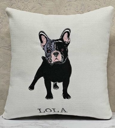A cushion featuring a black French Bulldog illustration named "Lola."