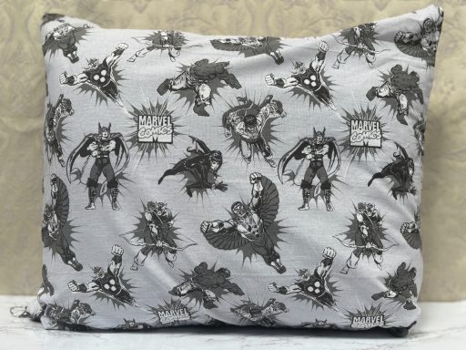 Pillow featuring a black-and-white comic-style superhero print.