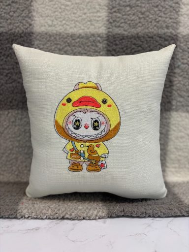 A cushion featuring a cartoon character in a yellow animal costume.