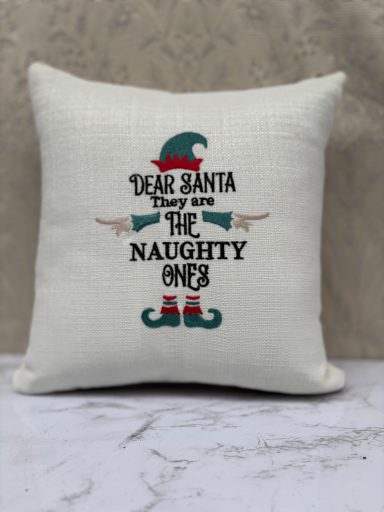 Cushion with the text "Dear Santa, They are the Naughty Ones" and playful elf graphics.