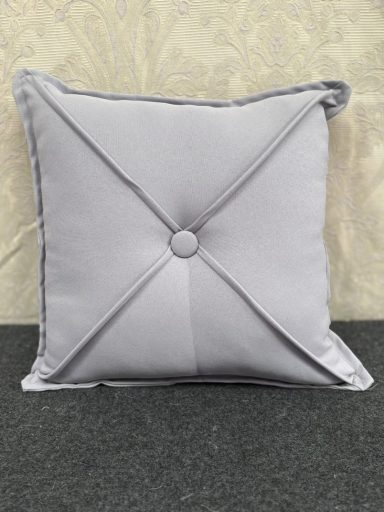 Square grey cushion with a button and decorative stitching.