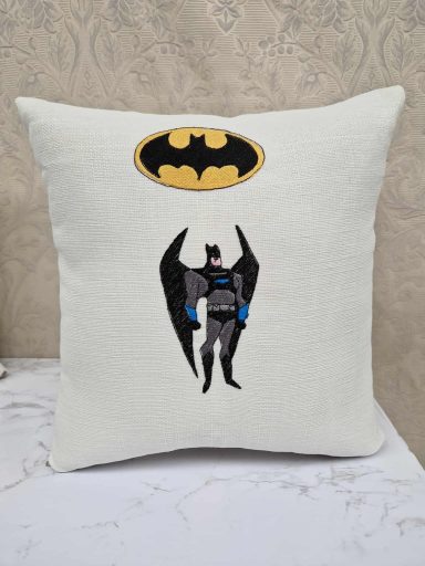Cushion featuring Batman design with a yellow logo above him.