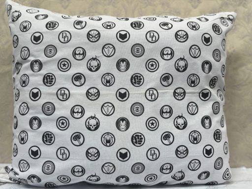 Cushion covered in a pattern of various black and white circular designs.