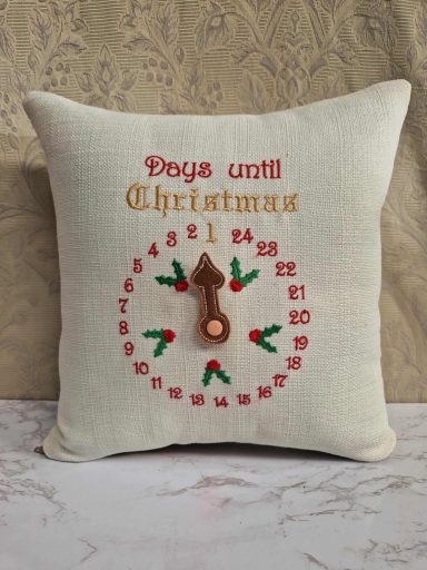 A decorative cushion with a clock design and "Days until Christmas" text.