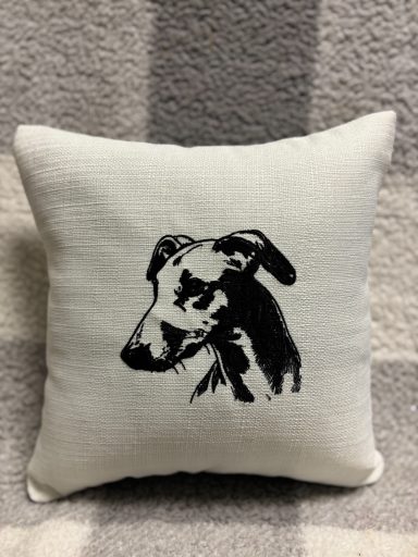 Pillow with a black and white illustration of a dog's head.