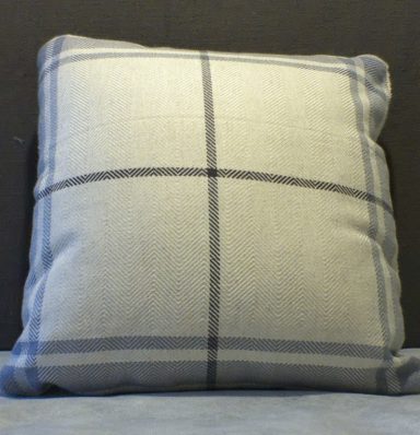 Square cushion with a light grey fabric and blue checkered pattern.