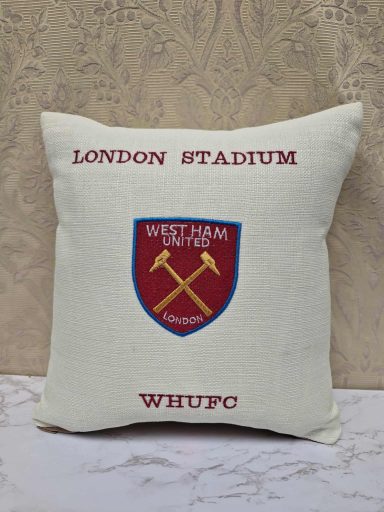 Cushion featuring the London Stadium and West Ham United logo with crossed hammers.