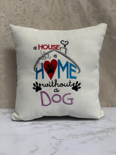Cushion with text: "A house is not a home without a dog" and decorative paw prints.