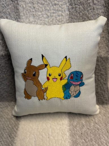 Cushion featuring Pikachu, Squirtle, and Eevee from Pokémon.