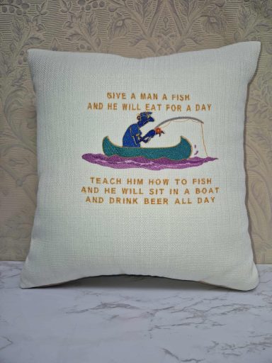 Cushion with a fishing-themed quote and colourful decorative design.