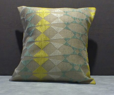Decorative cushion with a diamond pattern in shades of grey, teal, and yellow.