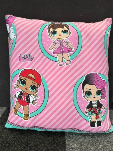 Pink cushion featuring LOL Surprise dolls in circular frames.