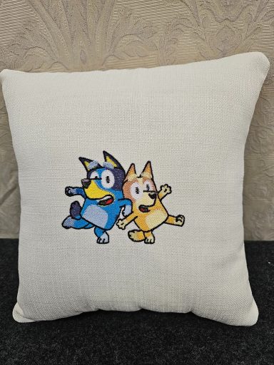 Cushion featuring two cartoon characters, a blue dog and a yellow dog, playing happily.
