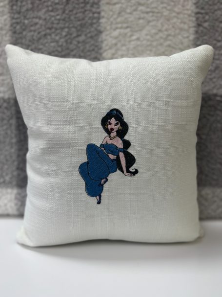 A decorative cushion featuring a blue-dressed princess character.