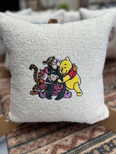 A fluffy pillow featuring Tigger and Pooh hugging each other.