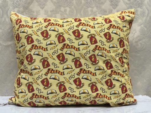 A yellow pillowcase with a repeated pattern of red and brown tacos.