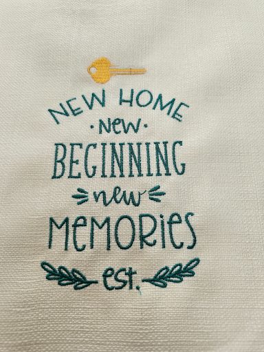 Text design featuring a key and the words "New Home, New Beginnings, New Memories, Est."