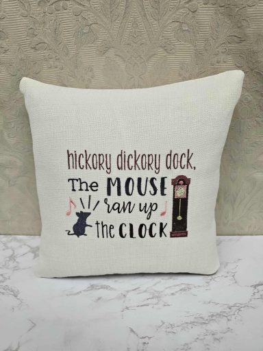 Cushion with "Hickory Dickory Dock" text and a clock illustration.