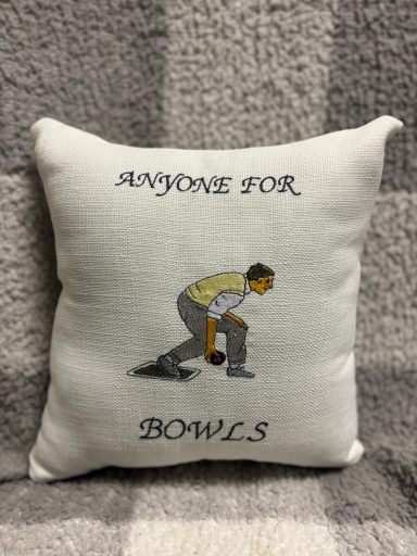 Cushion featuring a person bowling with the text "Anyone for Bowls?" above.