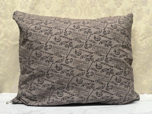 Brown decorative pillow with an intricate patterned design.