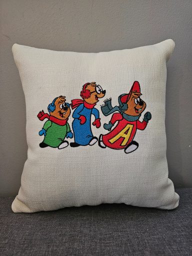 Three cartoon characters in colourful outfits, happily running together on a cushion.