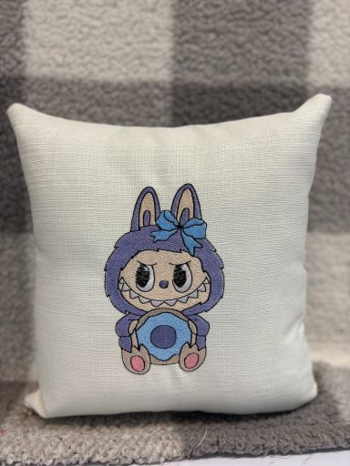 Square cushion featuring a cartoon character in a purple bunny outfit holding a circular object.