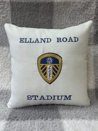 White cushion featuring the Leeds United badge and "Elland Road Stadium" text.