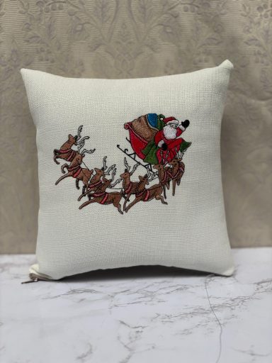 Throw pillow featuring Santa and reindeer in a festive design.