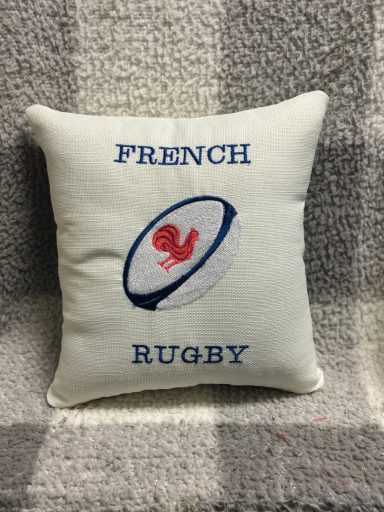 Pillow featuring a rugby ball graphic and the text "FRENCH RUGBY".