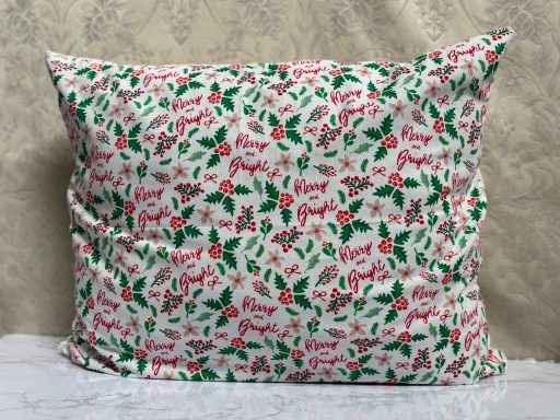 Floral cushion pillow with pink and green patterns on a white background.